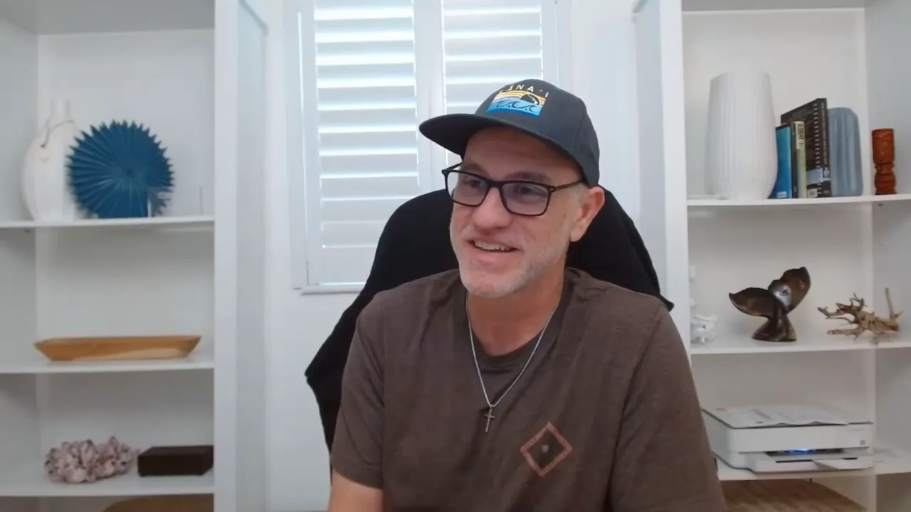 Host in a purple acoustic booth wearing white earbuds, clear head‑and‑shoulders shot